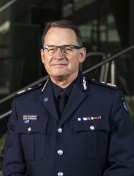 Decorative photo of Ross Guenther, Deputy Commissioner, Public Safety and Security, Victoria Police. He is smiling and in Victoria Police Dress Uniform