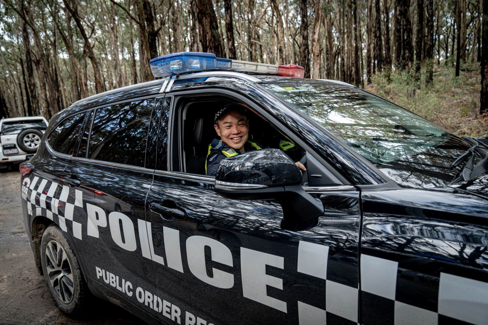 Officer driving a public order response police car. 