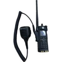 New style black police radio with an antenna, number pad and a mouth piece attached by a spiral cable