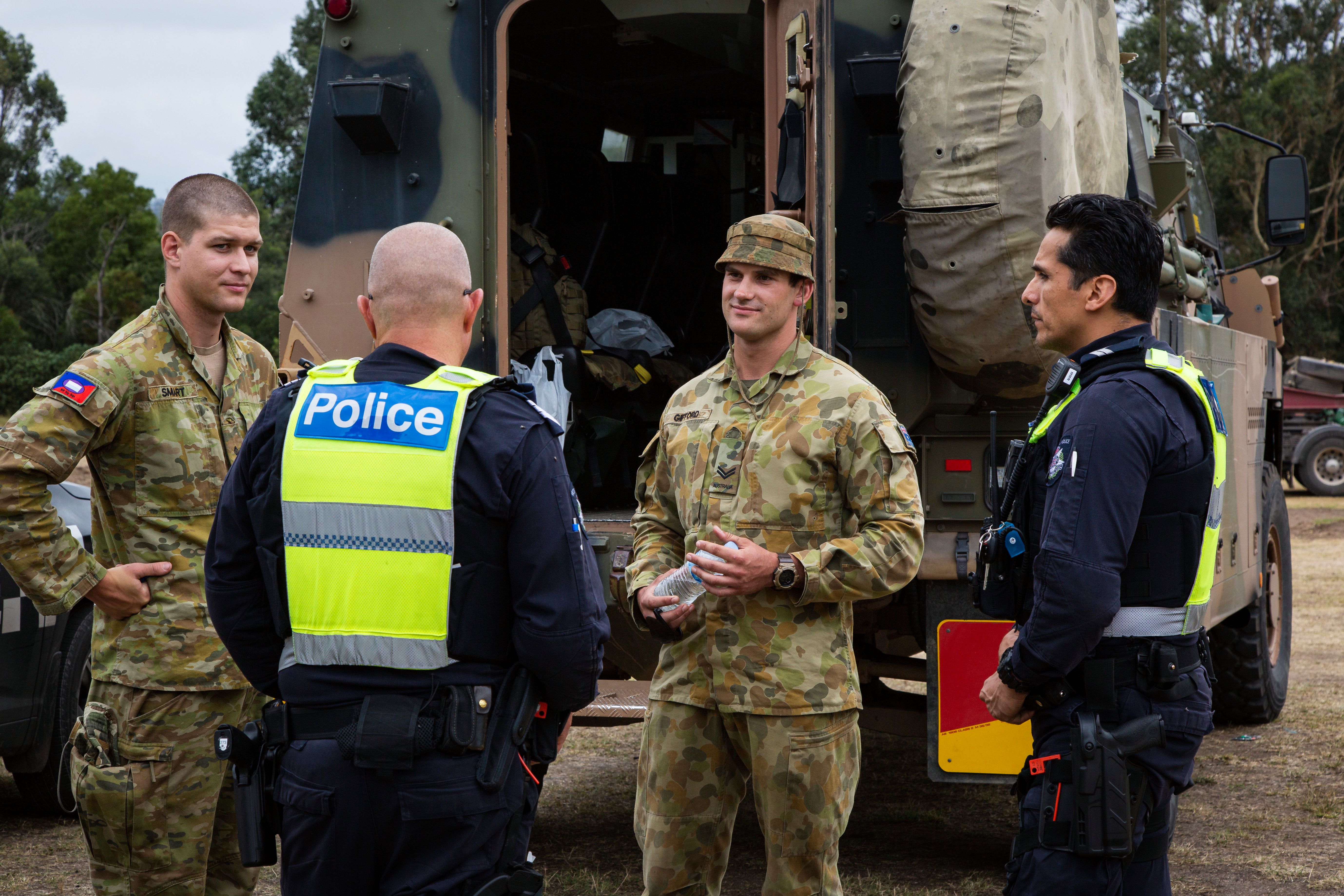 Victorian bushfires 2019-2020 - Police officers talking to army officers by an army truck