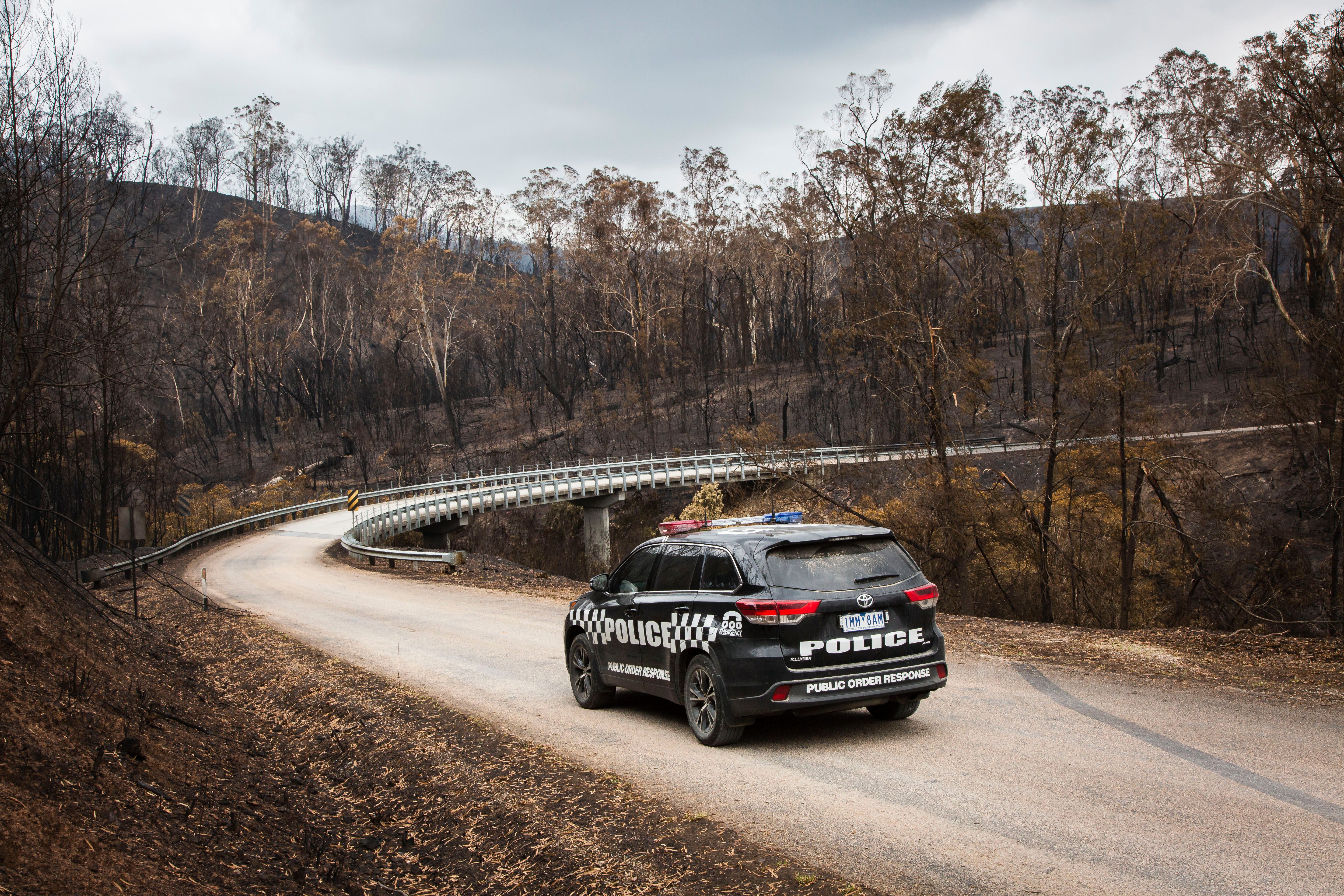 Victorian bushfires 2019-2020 - Police car driving on road after a bushfire