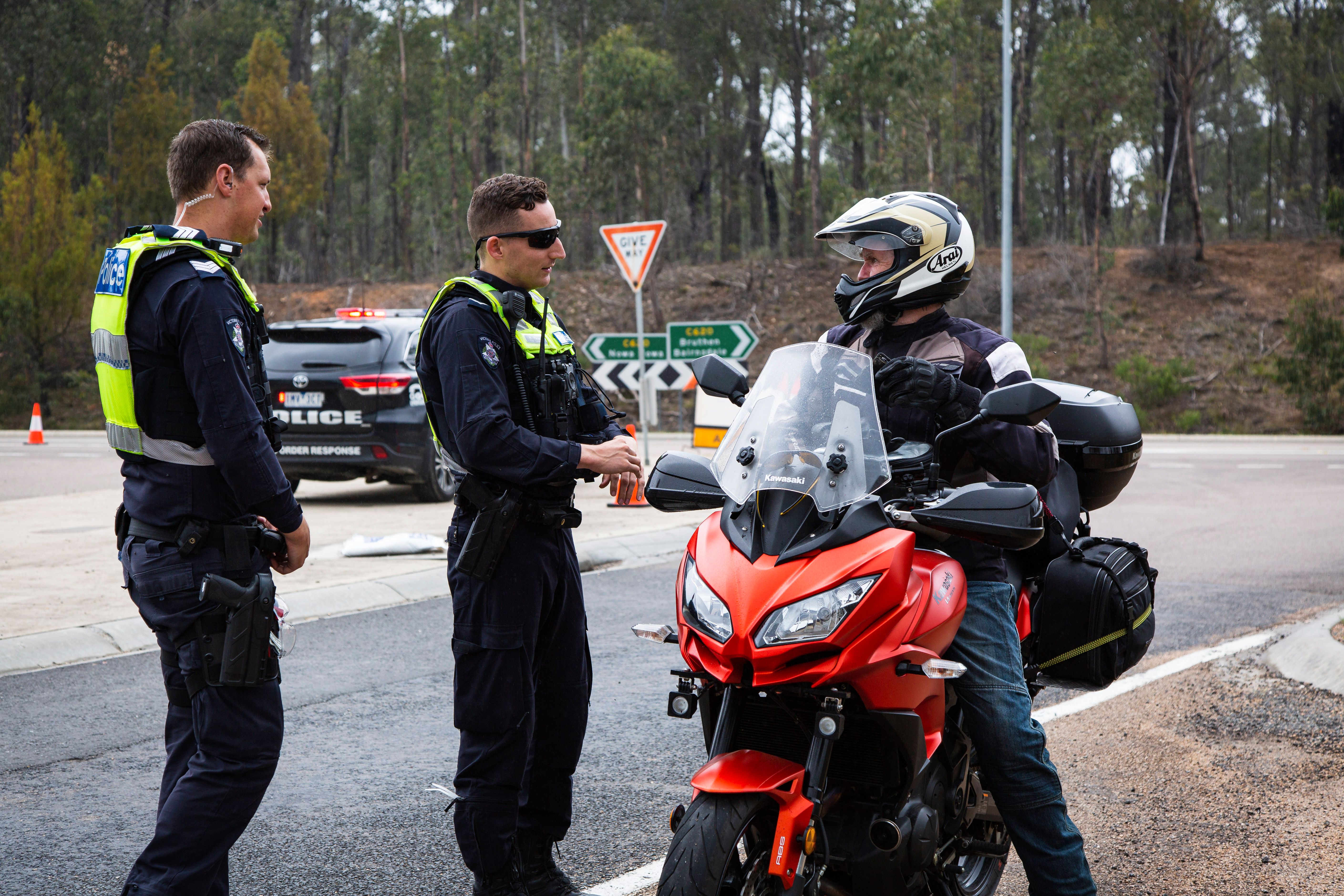 Victorian bushfires 2019-2020 - Two police officers talking to a motorcyclist