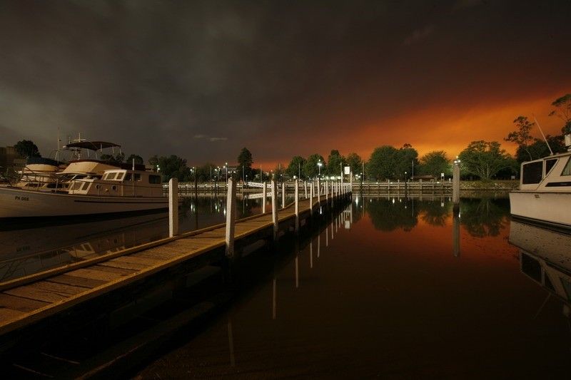 Victorian bushfires 2019-2020 - Marina pier with black and orange sky background