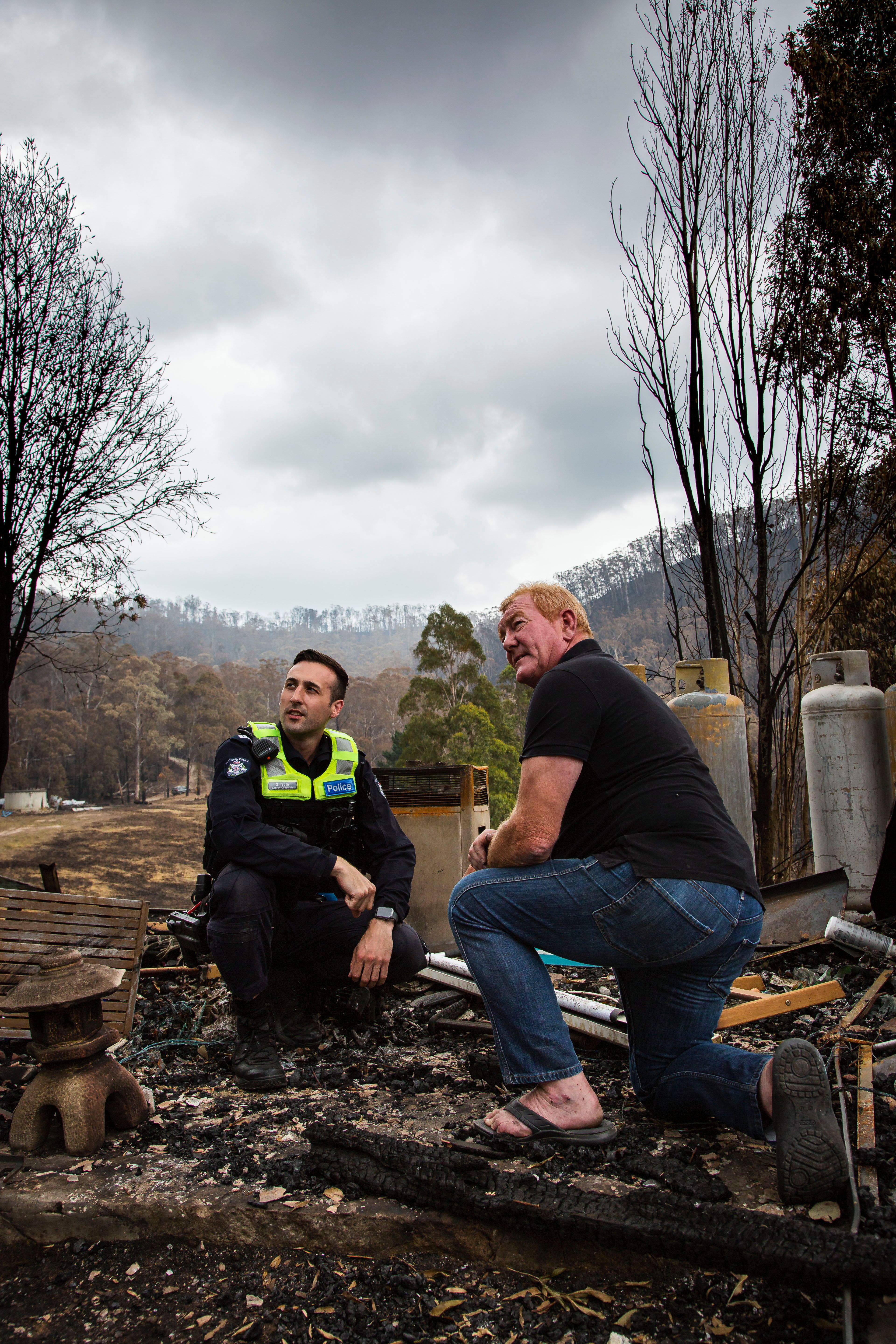 Victorian bushfires 2019-2020 - Police officer with a community member at a fire-destroyed property