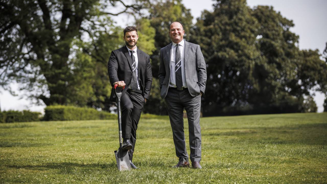 Two Victoria Police detectives in a park with a shovel