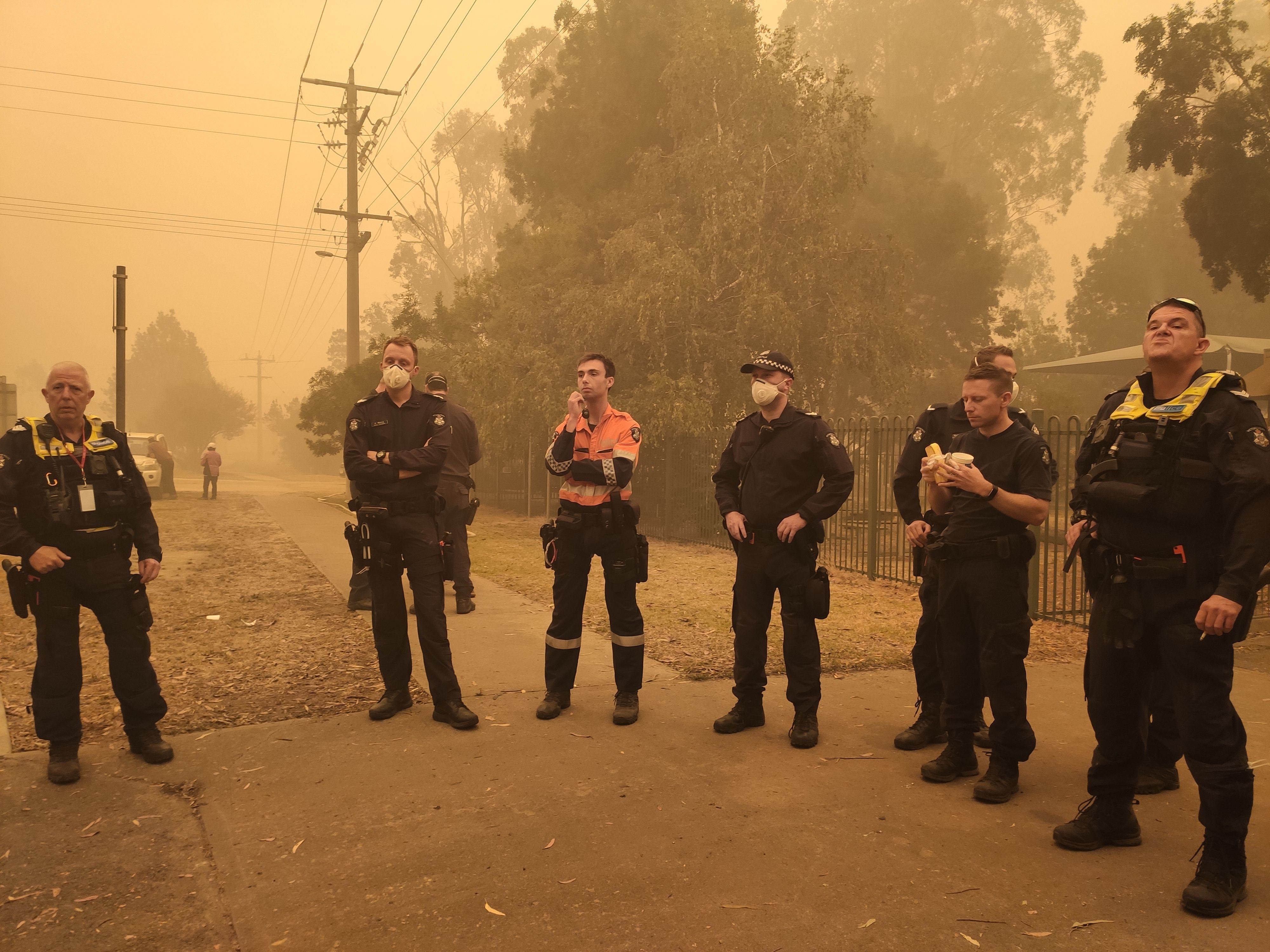 Victorian bushfires 2019-2020 - Multiple officers on a break outside in smoky conditions