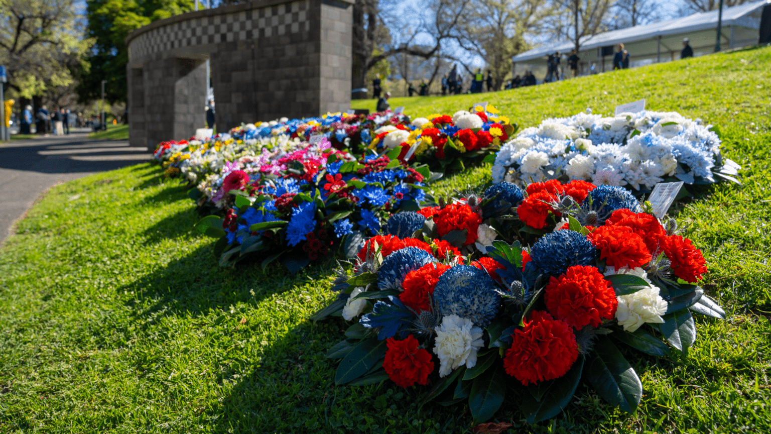 Wreaths of fresh flowers are laid out on the grass, before being placed at the Police Memorial.