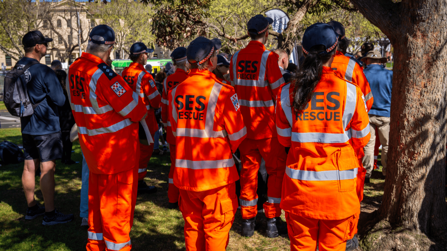 Members of Victoria State Emergency Service, wearing their orange uniforms, pay their respects at the Service.