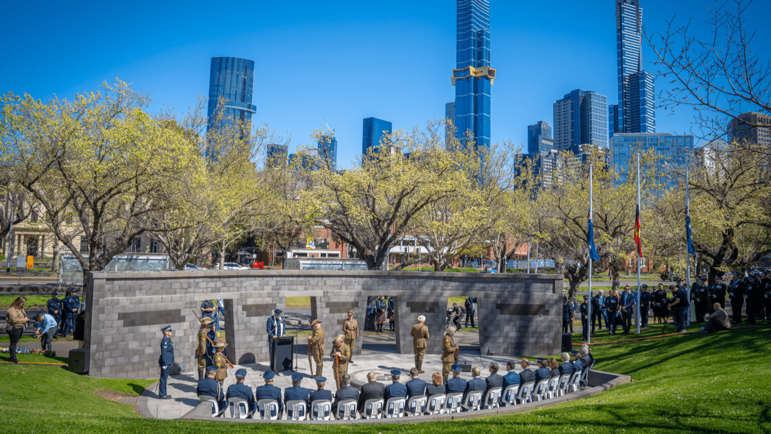 Shrine Guards in green uniform standing guard at the Police Memorial.