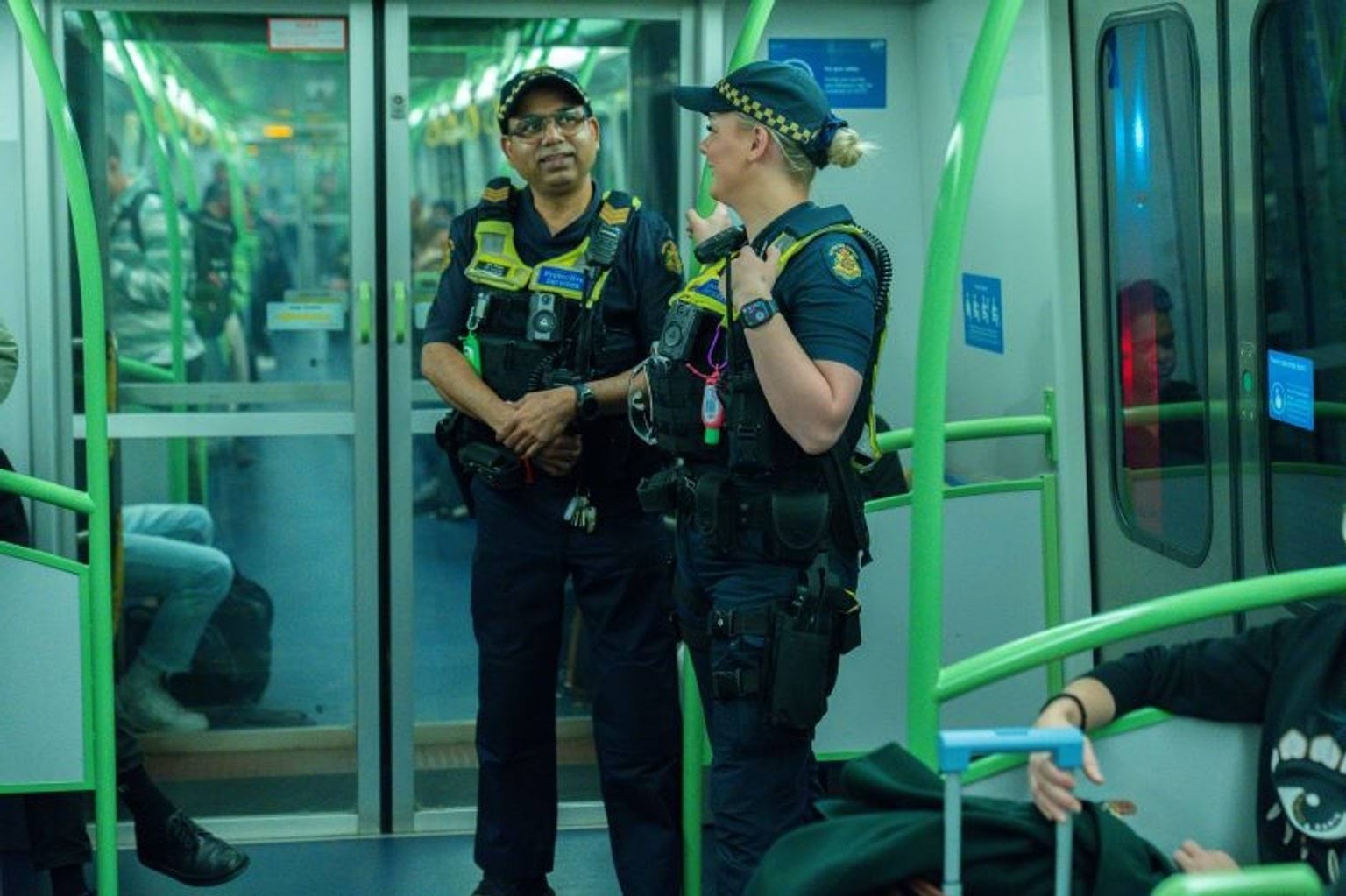 Two protective services officers on a train.