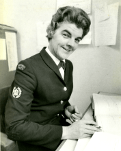 Catherine Margaret McVeigh in police uniform, at her desk. 